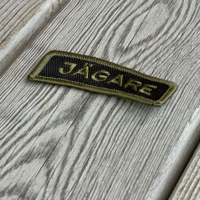 JÄGARE Sew On Patch Green/Black from TAC-UP GEAR seen at an angle