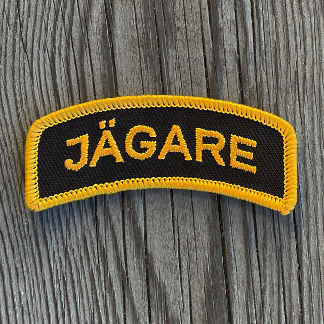 A JÄGARE Sew On Patch Orange/Black from TAC-UP GEAR seen from the front