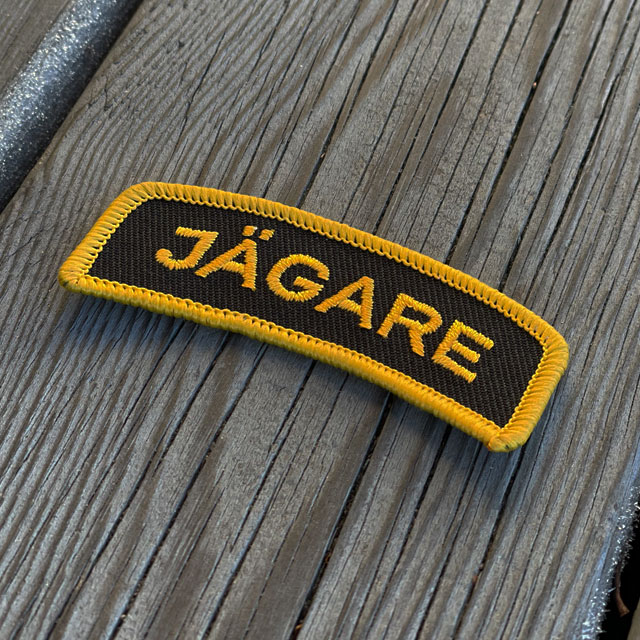 A JÄGARE Sew On Patch Orange/Black from TAC-UP GEAR seen from an angle