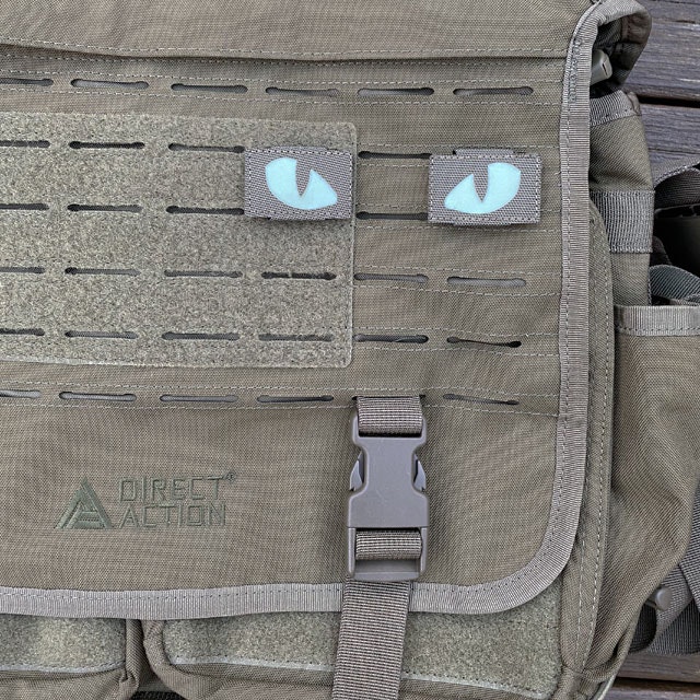 A pair of Lynx Glow Eyes Green Hook Tube mounted on a messenger bag from Direct Action