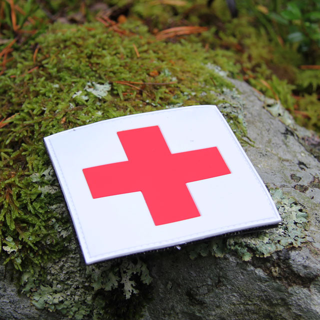 Stony background and a Medic Cross PVC Hook Patch.