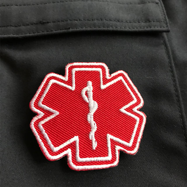 MEDIC Star of Life Red White Hook Patch on blue jacket.