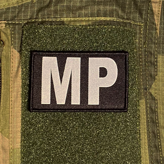 Militärpolis Patch mouted on a M90 camouflage shirt sleeve