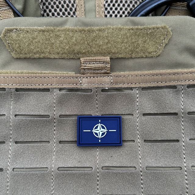 A NATO Flag PVC Hook Patch Small from TAC-UP GEAR mounted on a 5.11 Plate Carrier