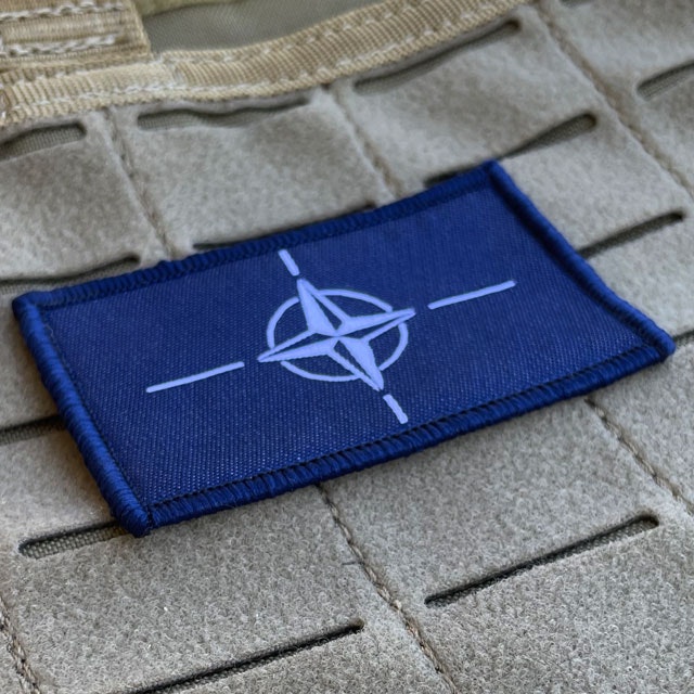 A NATO Flag Hook Patch from TAC-UP GEAR mounted on a 5.11 plate carrier
