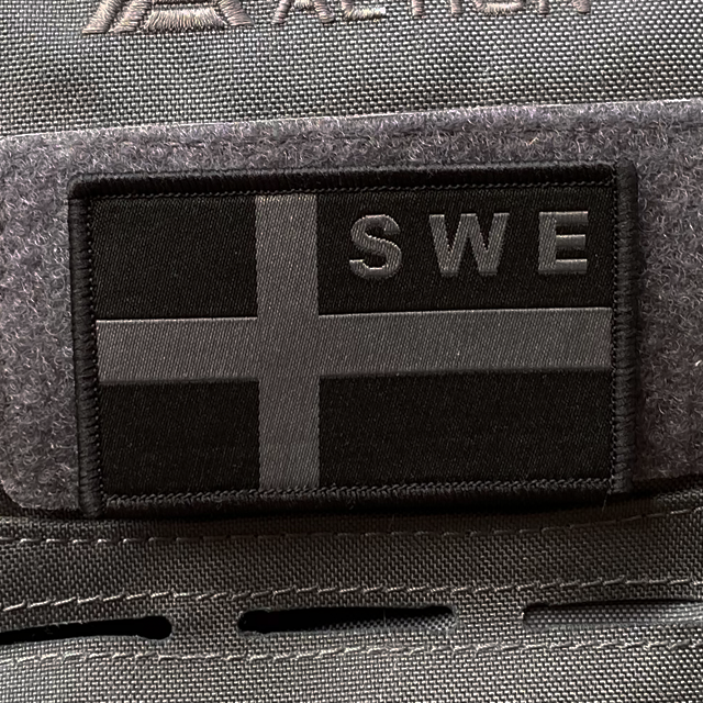 Sweden Flag OPS Nylon Black/Grey Patch mounted with velcro on a grey rucksack