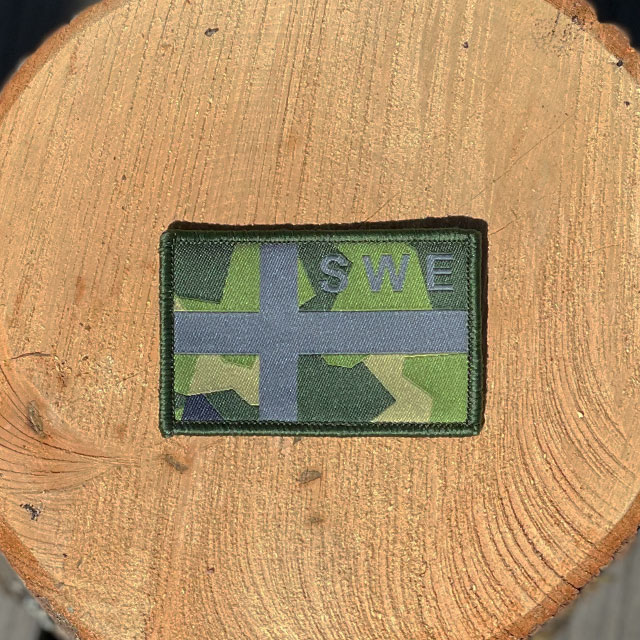 Sweden Flag OPS M90 Patch from TAC-UP GEAR on a piece of wood