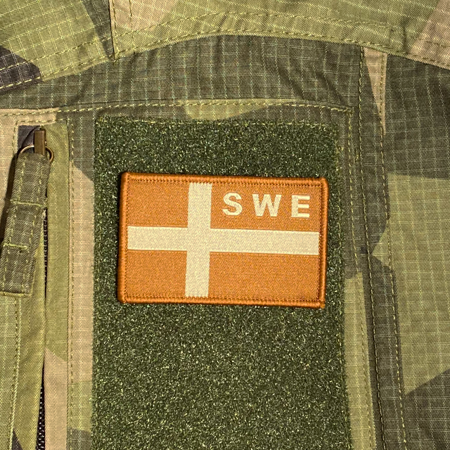 Sweden Flag OPS Sand Patch monted on a M90 camouflage shirt sleeve