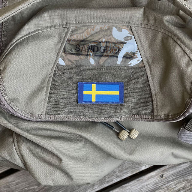 A Sweden Long Flag Blue from TAC-UP GEAR mounted on a bag