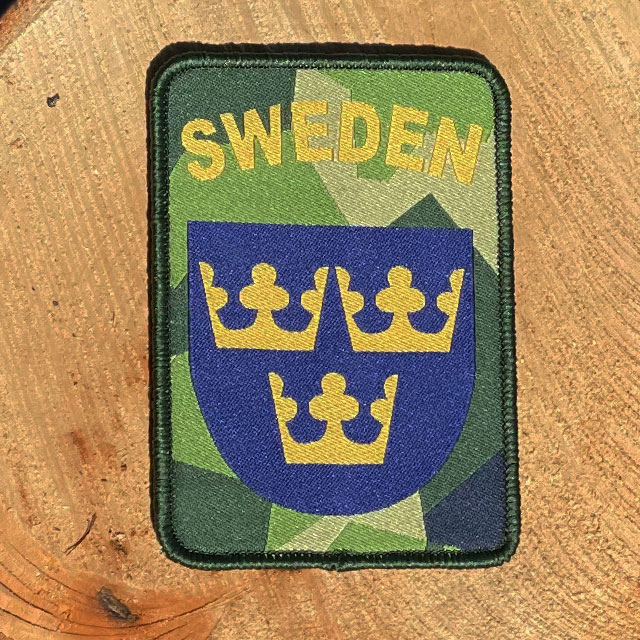 Sweden Hook Patch M90 from TAC-UP GEAR with wooded background