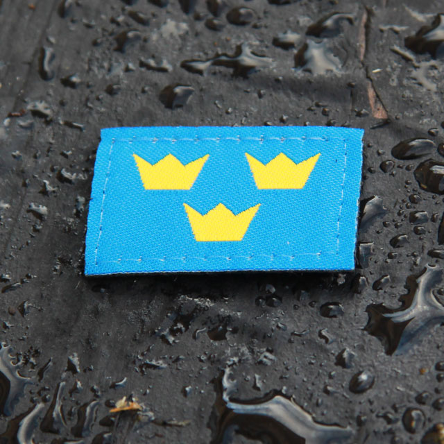 Three Crowns Morale Patch on wet background.