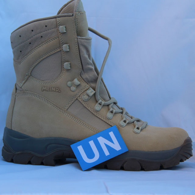 Showing the size of a United Nations Hook Patch Large with a desert boot as background.