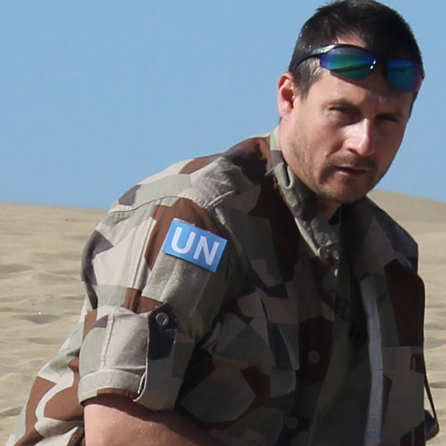 A United Nations Hook Patch Large worn in the desert during product photoshoot.