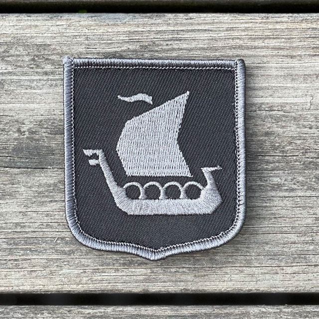 A close up picture of a Viking Ship Shield Large Grey and Black Hook Patch