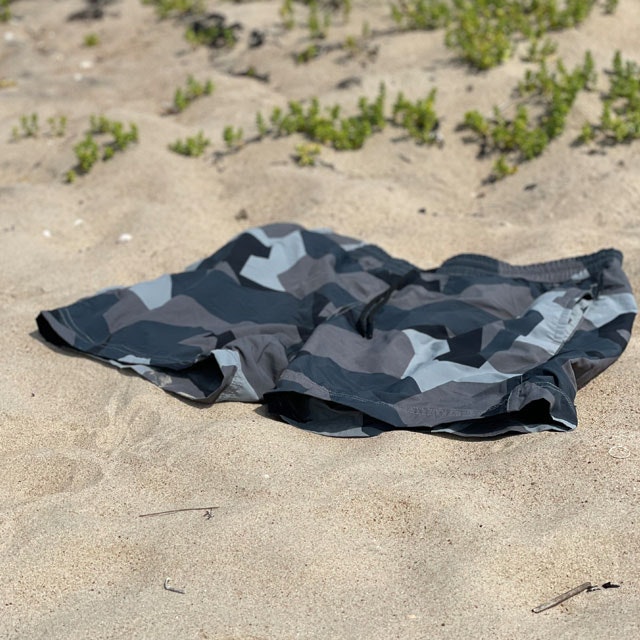 POSEIDON Swim Shorts M90 Grey lying on the beach