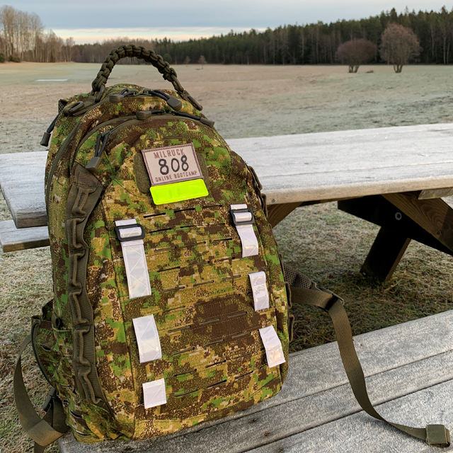 Reflective Stripes Silver mounted on camouflage rucksack during milruck