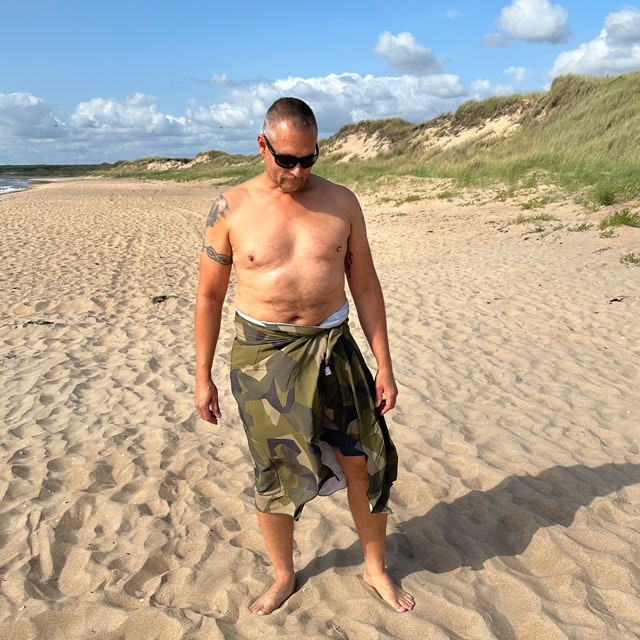 Sarong M90 Camouflage from TAC-UP GEAR is wrapped around the body on the beach