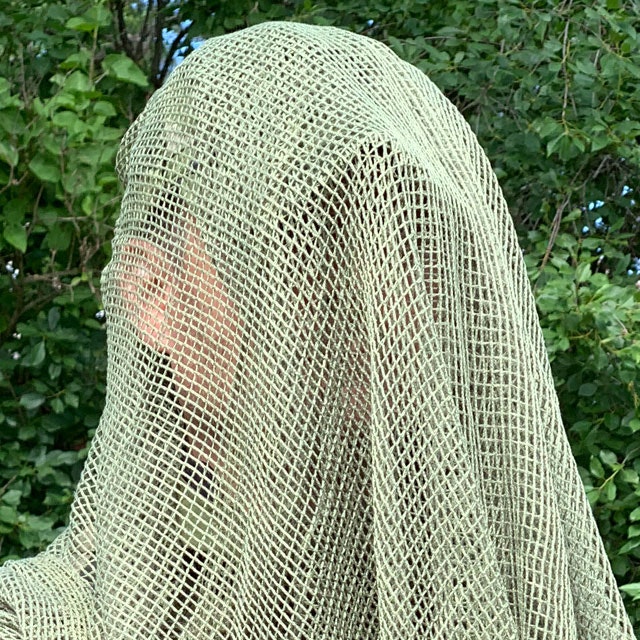 Draped over cap is a Scrim Net Scarf Green