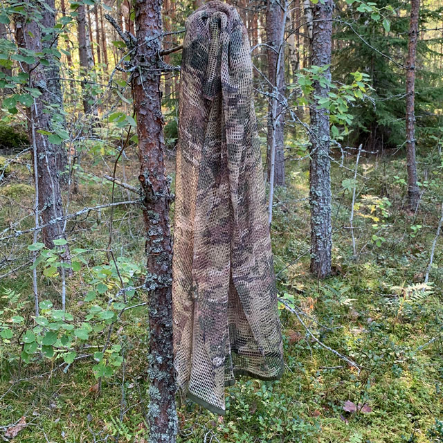 Scrim Net Scarf Multicam hanging on a tree in the Swedish forest
