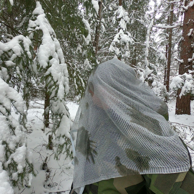 Scrim Net Scarf White Moss draped over man in Swedish winter forest