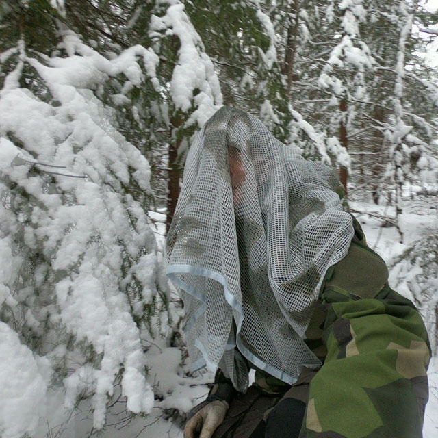 Scrim Net Scarf White Moss draped over man in M90 in Swedish winter forest