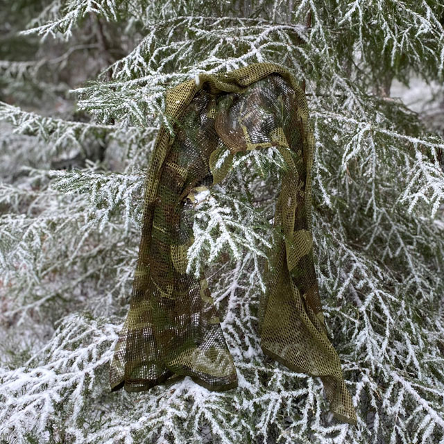 a Scrim Net Scarf Woodland on branches of a tree