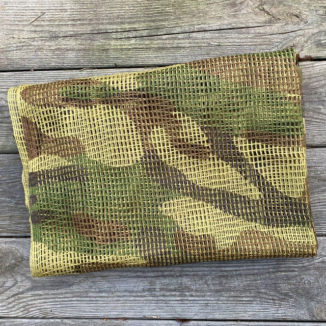 The swooping camouflage on a Scrim Net Scarf Woodland from Tac-Up Gear