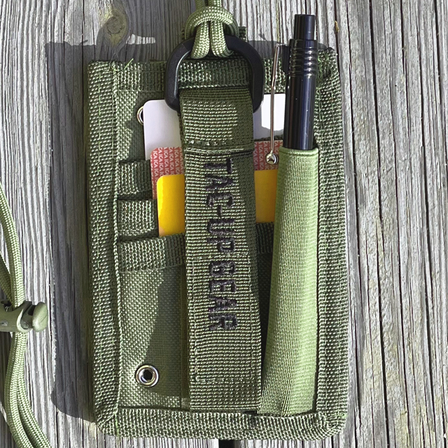 A kitted Tactical Neck ID Card Holder Green from TAC-UP GEAR seen from the back