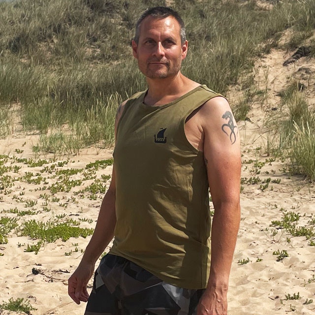 Tank Top Khaki Green from TAC-UP GEAR on model at the ocean seen from the left side