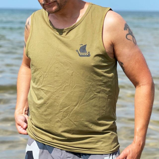 Tank Top Khaki Green from TAC-UP GEAR on model at the ocean seen adjusting it from an angle