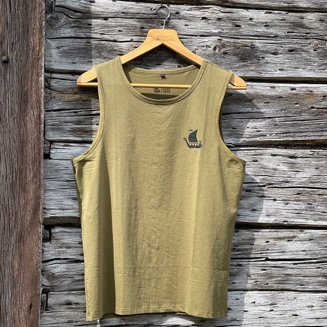 A Tank Top Khaki Green from TAC-UP GEAR on a hanger with old woodhouse background