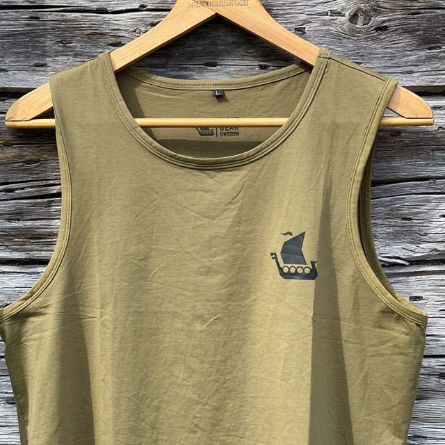 A closer look on a Tank Top Khaki Green from TAC-UP GEAR on a hanger with old woodhouse background