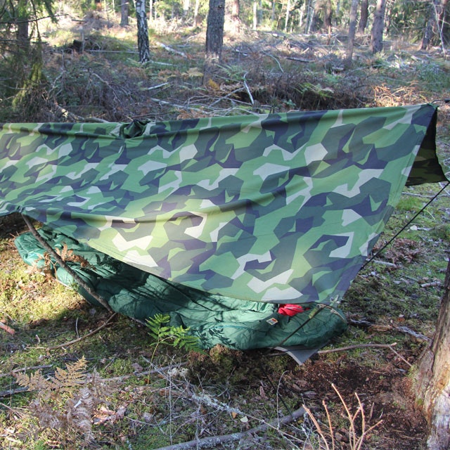 Tarp Poncho M90 set up as a basha in the Swedish forest.