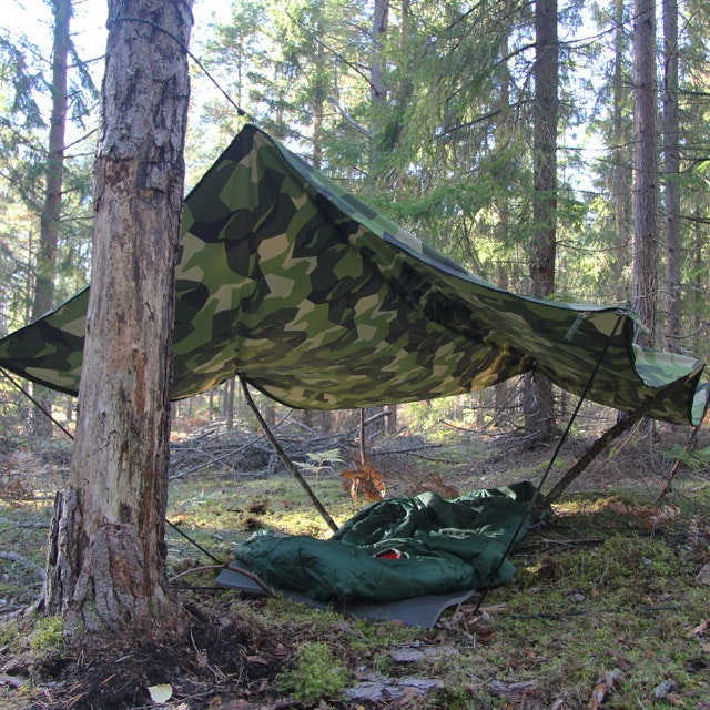 Tarp Poncho M90 used as roof ofver a sleepingmat and sleepingbag in the Swedish forest.