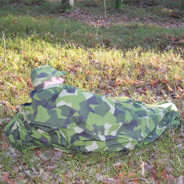 Seen using the Tarp Poncho M90 as a full body cover in Swedish autumn scenery.