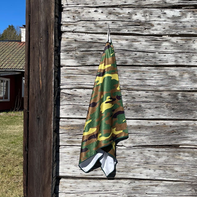 Towel Camouflage from TAC-UP GEAR hanging on a house wall