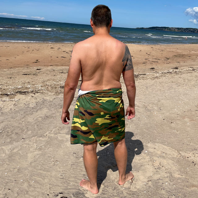 Towel Camouflage from TAC-UP GEAR wrapped around models waist on the beach and seen from the back