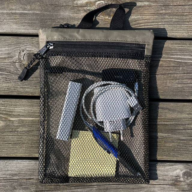 Filled with items, the back net pocket on a Zipper Net Pouch Khaki from TAC-UP GEAR