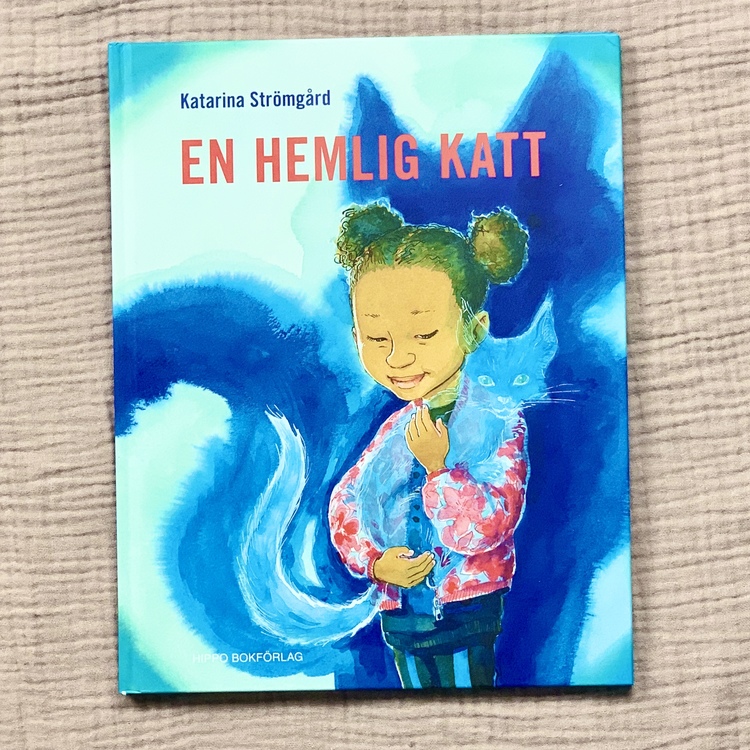 Bilderbok En hemlig katt, författare och illustratör Katarina Strömbård, Hippo förlag. Mångfald bland karaktärerna där barn med mörk hy är representerad, mixat barn och mixad familj.