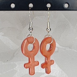 Örhängen med små kvinnosymboler i bright orange