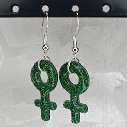 Örhängen med små kvinnosymboler med glitter grönt