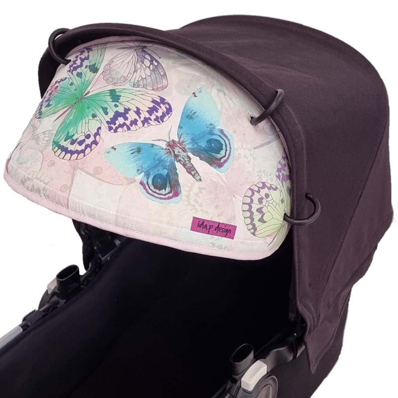 Solskydd barnvagn med rosa fjärilar
