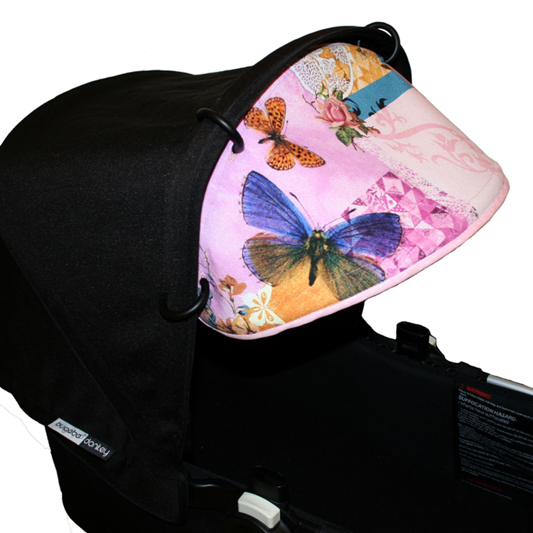 Solskärm till barnvagn. Fästes med barnvagnsringar i suffletten