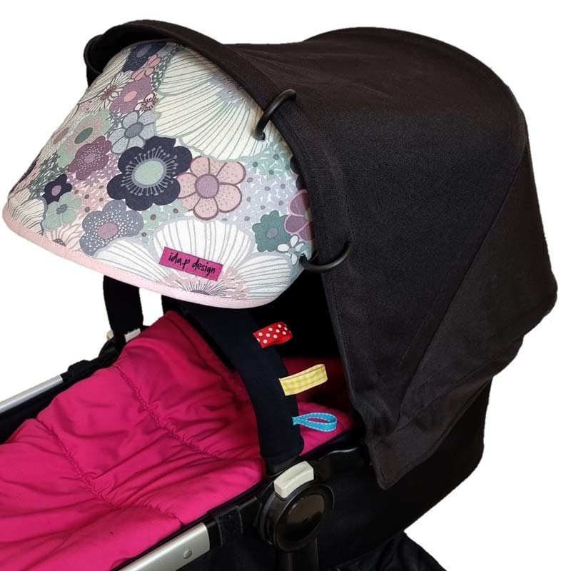 Solskydd barnvagn i tyg med lila och rosa blommor