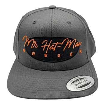 YP6606 Classic Snapback Dark Grey with black front oval and orange text