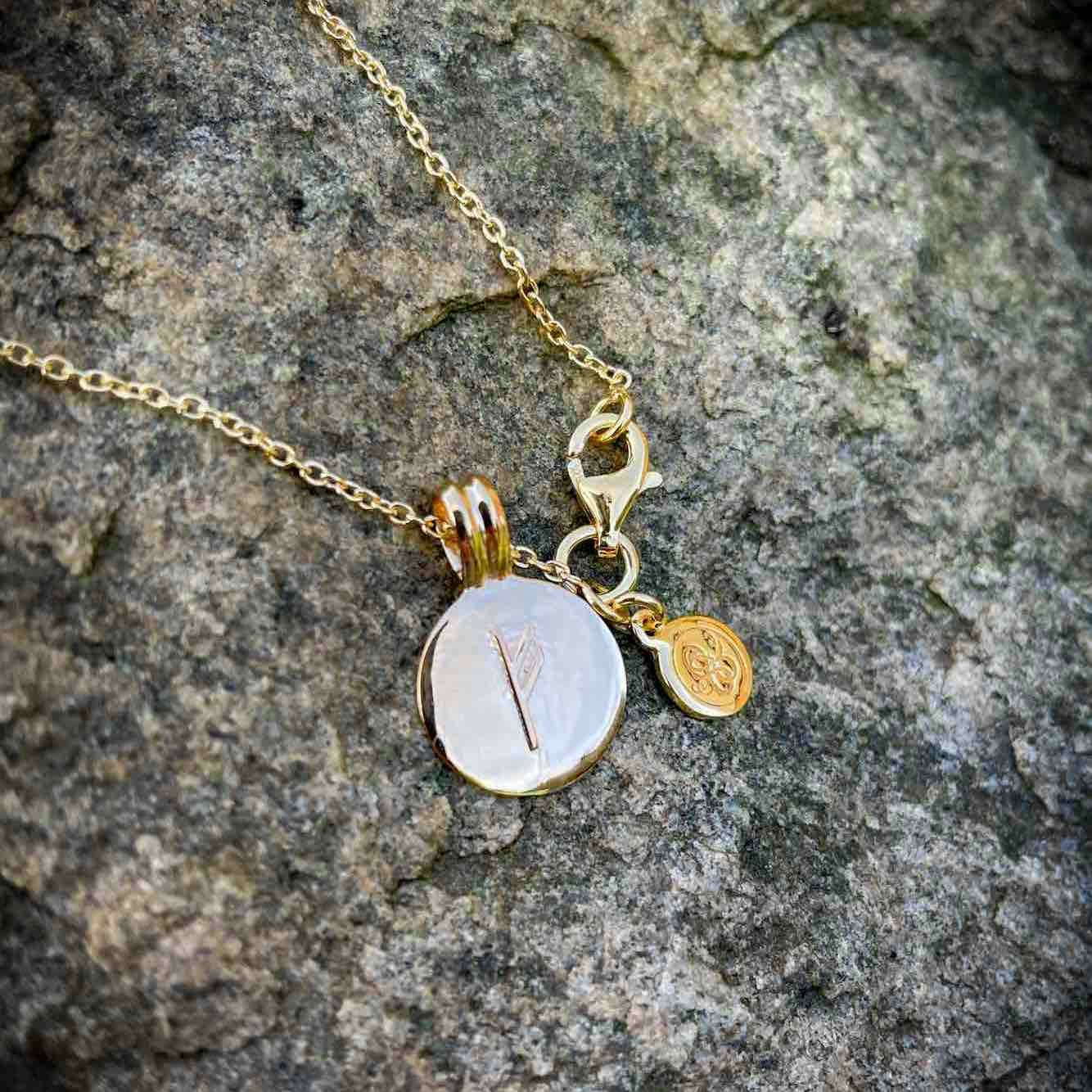 Soldiser Gold Fehu Rune Necklace on stone