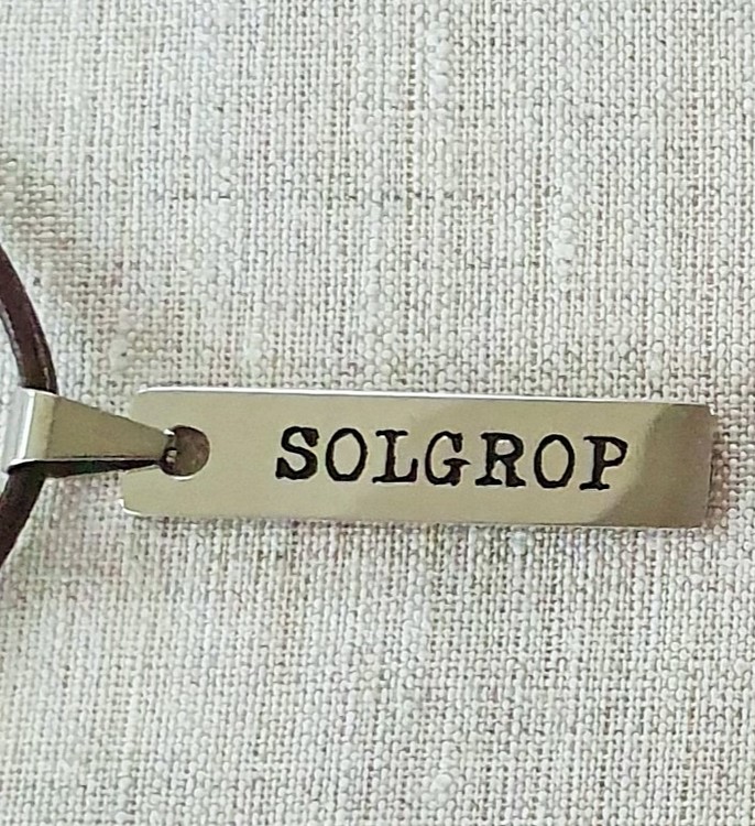 Solgrop-berlock med läderband