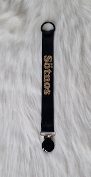 Sötnos guldglitter, svart clips