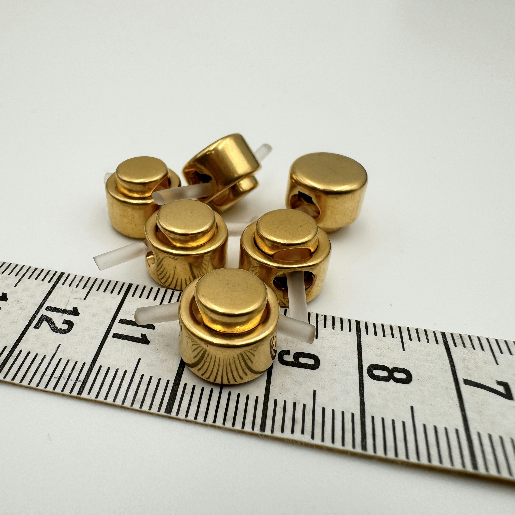Snörstopp guld Escad*