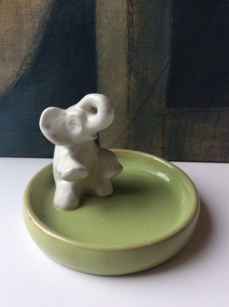 Sitting elephant in green bowl